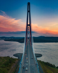 Sunset aerial view of famous cable-stayed bridge to Russky island from Vladivostok city in Far East of Russia - 490293177