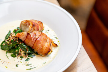 fried bacon rolls with sauce and herbs