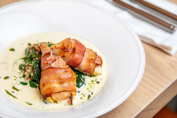 fried bacon rolls with sauce and herbs