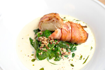 fried bacon rolls with sauce and herbs