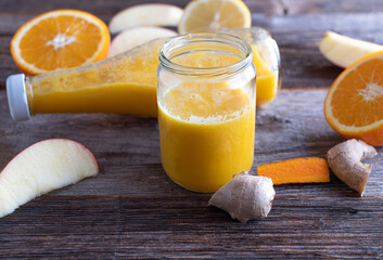 Drink for strengthen immune system with a orange, apple, ginger, turmeric shot