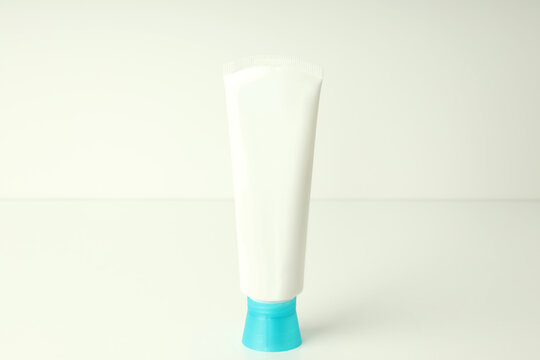 Blank tube of toothpaste on white table