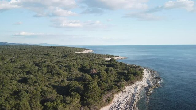 Coastline without people with the crystal blue Mediterranean sea in the sunset, 4K drone footage in Dugi otok, Croatia