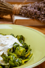Tagliatelle pasta with spinach and green pea pesto, selective focus