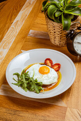 breakfast fried eggs with beefsteak, arugula and sun-dried tomato