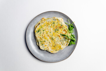 Filled with cheese and cilantro fpancakes on plate on white background