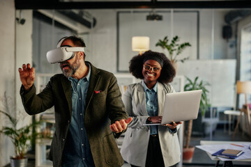 Business persons with virtual reality headset and laptop in the office
