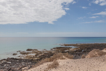 Fototapeta na wymiar Impressive beaches of dunes and rocks with turquoise water on the island of Fuerteventura