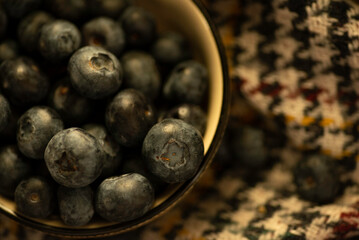 Black Berries in a Bowl on a Wood Table