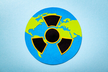 Papercut concept with the Earth and the symbol of radioactivity