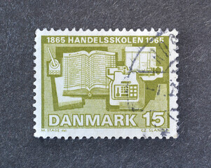 Cancelled postage stamp printed by Denmark, that shows First school of commerce, circa 1965.