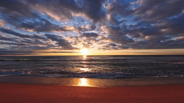 Beautiful sunrise over the sea and beach. Sunset over ocean waves.