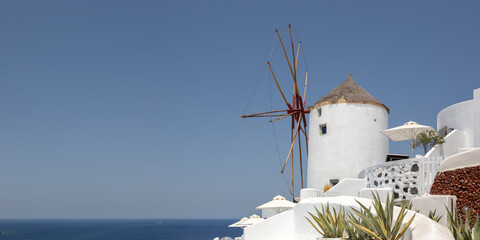 Windmill on Santorini island holidays in Greece travel traveling Oia town Mediterranean Sea...