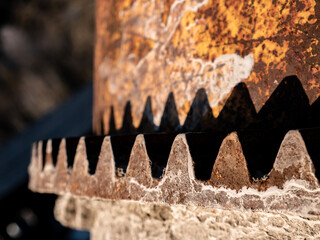Macro view of the teeth of a concrete mixer bowl gear rim and the shadow of the teeth projecting on...