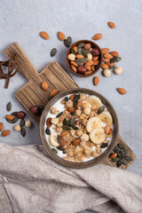 Healthy breakfast of granola with nuts, banana and yogurt