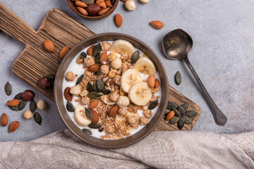 Healthy breakfast of granola with nuts, banana and yogurt