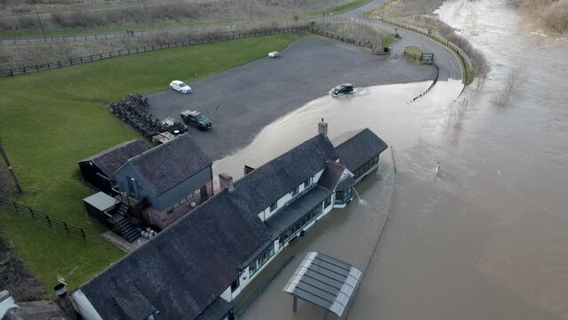 River Severn busts its banks and floods pub water pumped out drone view UK