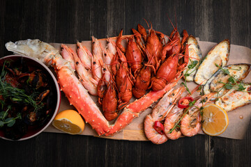 a plate of various snacks, seafood, mussels, boiled crayfish, shrimps