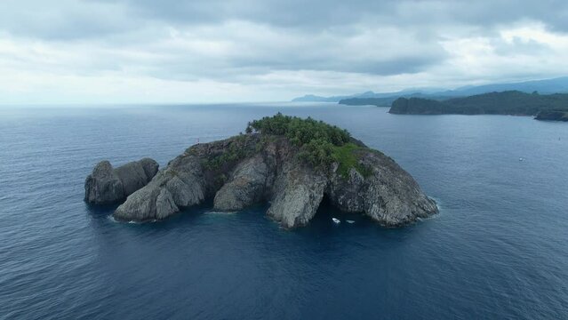 Aerial view around the Ilheu de Santana islet, in Sao Tome - circling, drone shot
