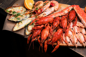 a plate of various snacks, seafood, mussels, boiled crayfish, shrimps