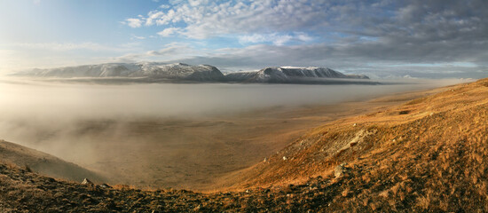 Harsh landscapes of northern nature, morning mist in a mountain valley
