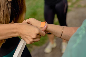 Female trainer giving id bracelet for private fitness workout entrance
