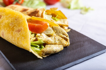 Chicken wrap with salad and tomato. Idea for a tasty and healthy lunch.