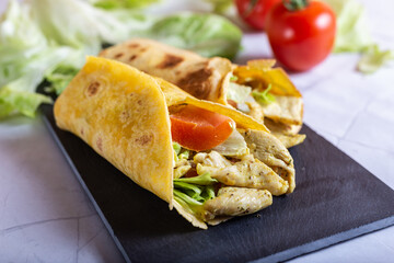 Chicken wrap with salad and tomato. Idea for a tasty and healthy lunch.