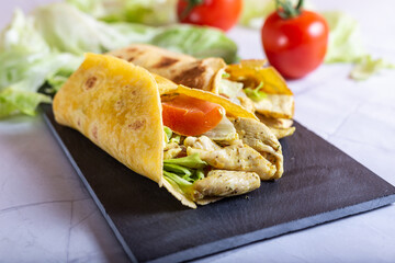 Chicken wrap with salad and tomato. Idea for a tasty and healthy lunch.