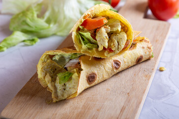 Chicken wrap with salad and tomato. Idea for a tasty and healthy lunch.