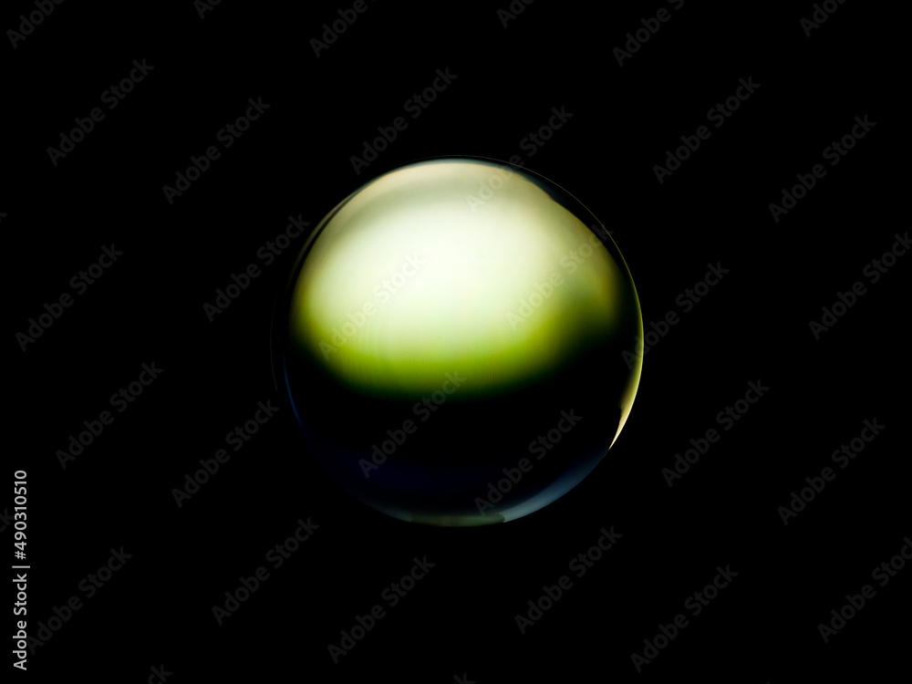 Wall mural blurry image of a shiny crystal ball with abstract blurry colorful pattern.