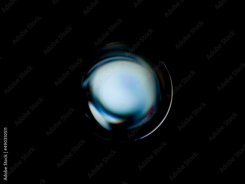 Wall mural blurry image of a shiny crystal ball with abstract blurry colorful pattern.