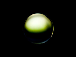 Blurry image of a shiny crystal ball with abstract blurry colorful pattern.