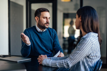 Helpful caucasian executive, looking for a solution to company problem, with female partner.