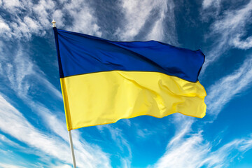 Ukrainian blue and yellow bicolor national flag on blue sky background. Ukraine fight for Freedom concept