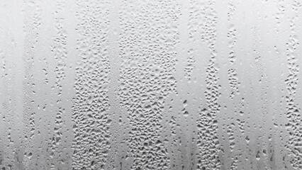 Texture of the rain on the glass, steamy window with water drops made in dull day