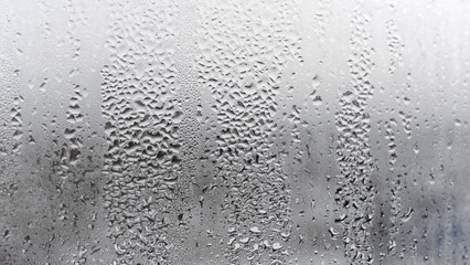 Texture of the rain on the glass, steamy window with water drops made in dull day