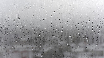 Texture of a drop of rain on a glass wet transparent background, humidity and foggy blank