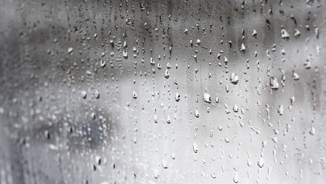 Texture of a drop of rain on a glass wet transparent background, humidity and foggy blank