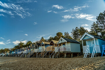 colourful, wooden beach huts on the beach