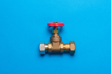 Water valve on the blue background flat lay.