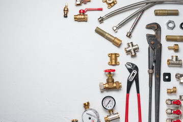 Plumbing equpment parts and wrenches on the white flat lay background with copy space. Pipeline...
