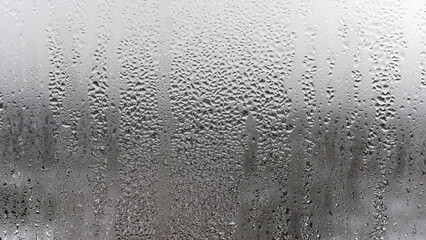 Close up for misted glass with droplets of water draining down. Dripping Condensation, Water Drops Background Rain drop Condensation Texture