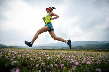 Female runner running in spring field