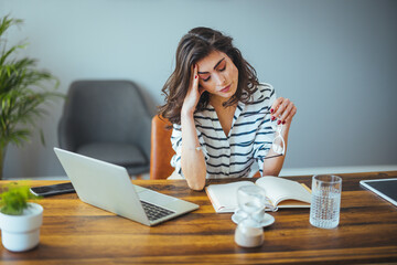 Young tired working woman at work. Shot of a young businesswoman with her eyes closed sitting in...