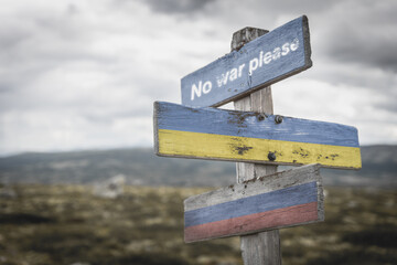 no war please text quote on wooden signpost outdoors on nato colored flag, ukrainian flag and...