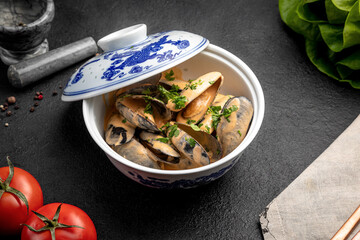 mussels in sauce in a ceramic dish on a dark decorated background