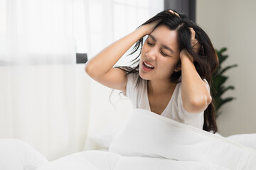 Waking up with a headache. Beautiful woman can't fall asleep moving restless on bed. Young woman having bad dream sleep troubles trying can not sleep.