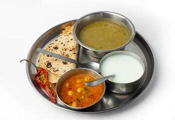 Indian home made food plate or indian thali with steel plate and utensils