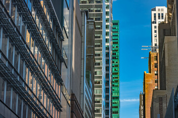 Fototapeta premium City skyscraper buildings lined up together, close up architecture, NYC travel tourist destination.